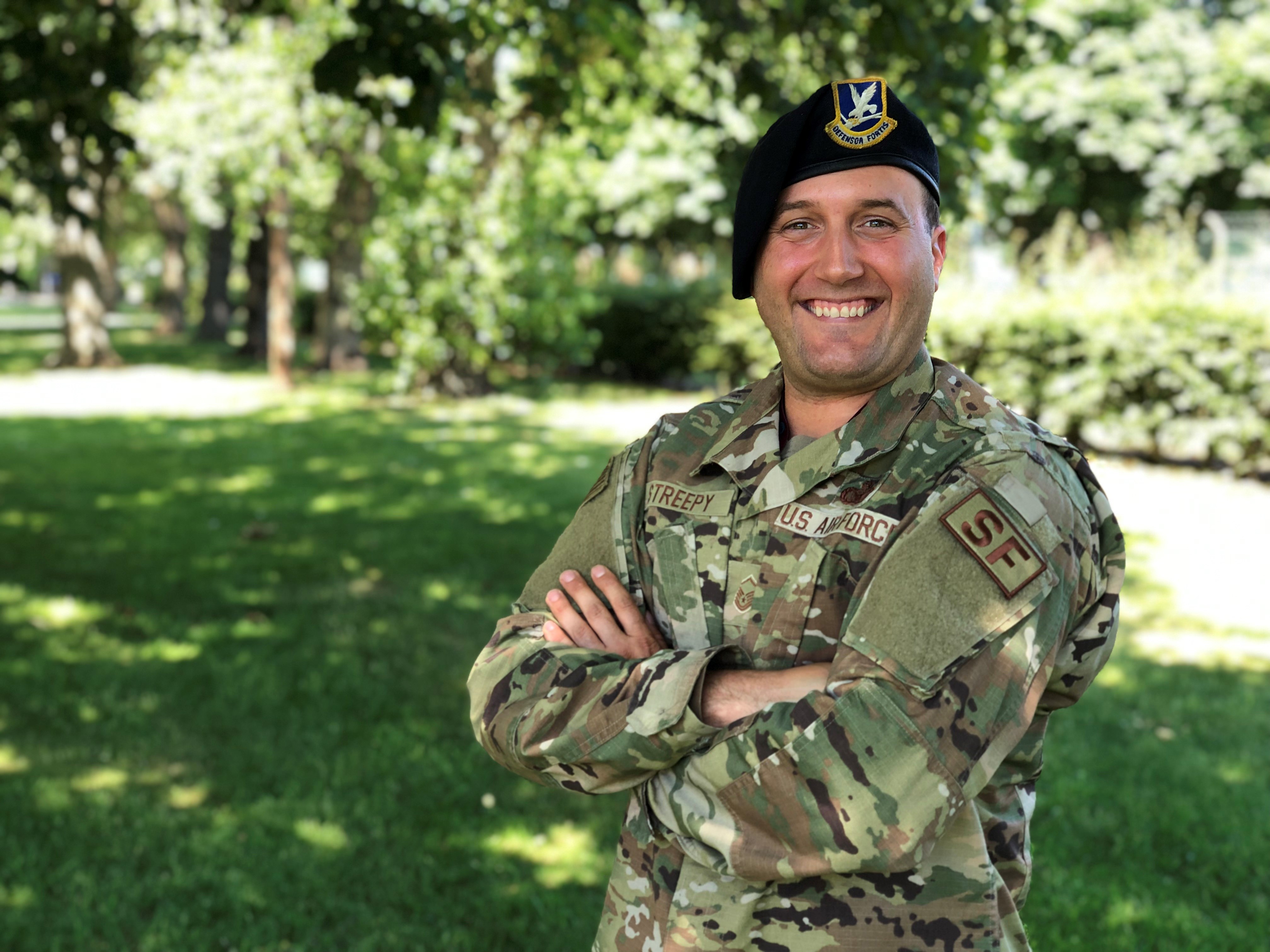 Image shows US soldier smiling ouside.